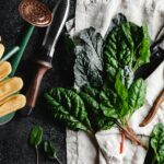 green leaves beside brown wooden rolling pin