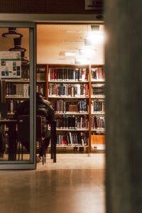 A person sitting in a library with books