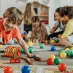 Boy in Orange Shirt Playing on the Floor