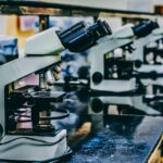 white microscope on top of black table