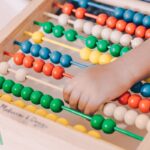 person holding red and blue abacus